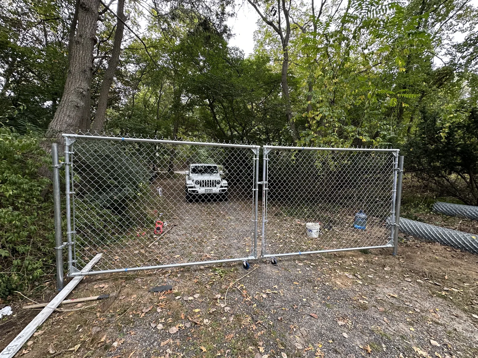Chain-link construction fencing and gates securing the single-family development site