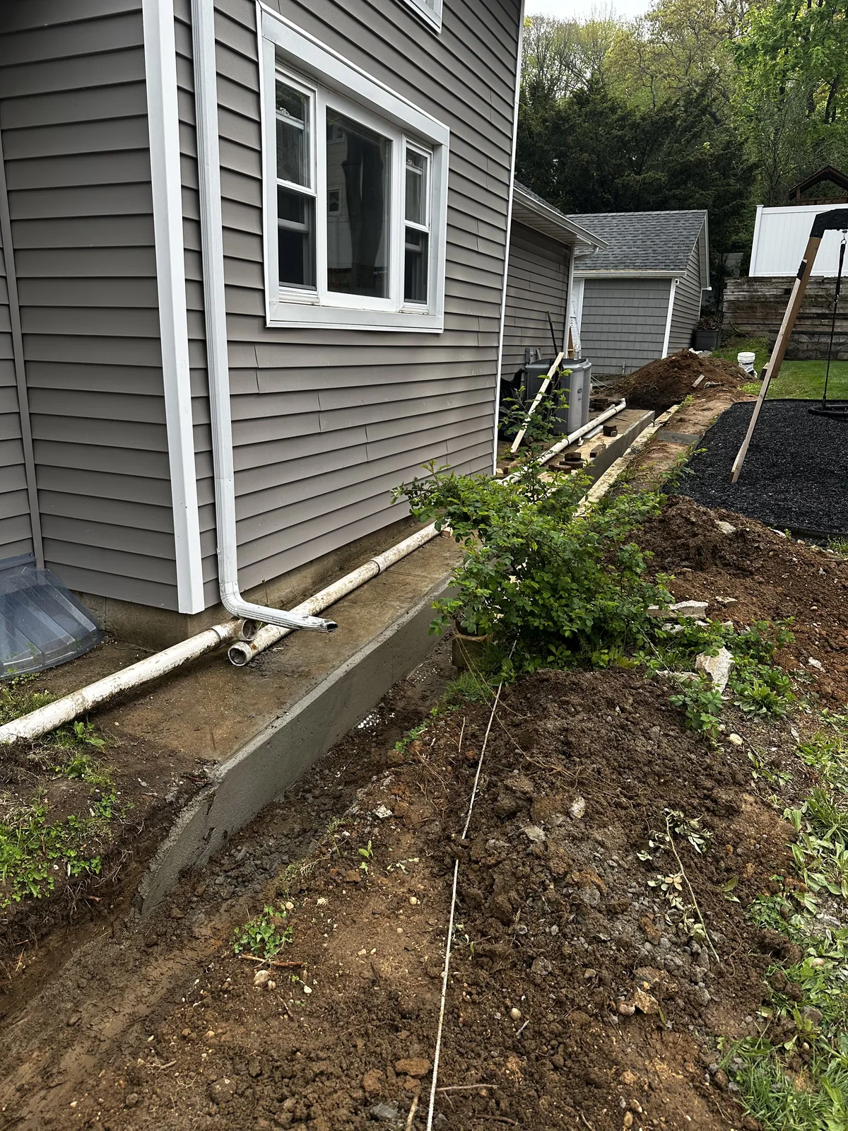 Residential exterior drainage channel and piping improvements