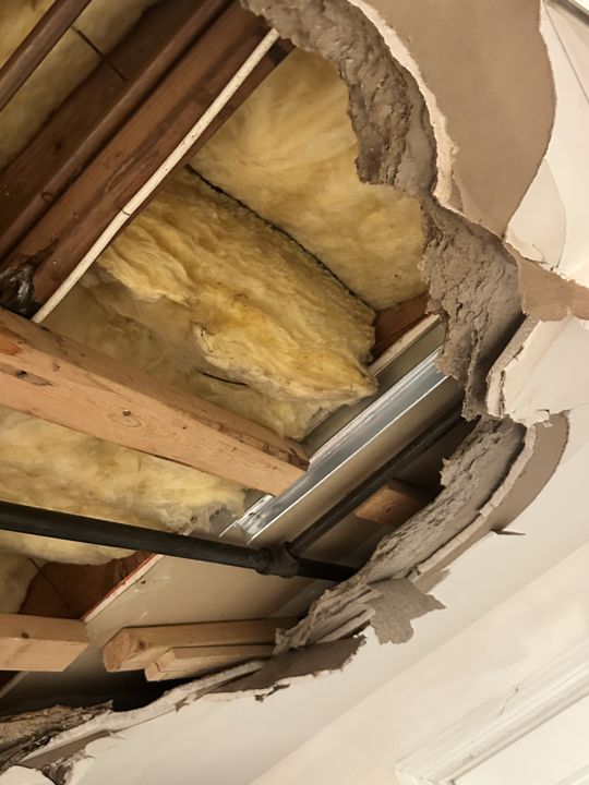 Attic above the leak, insulation pulled back.