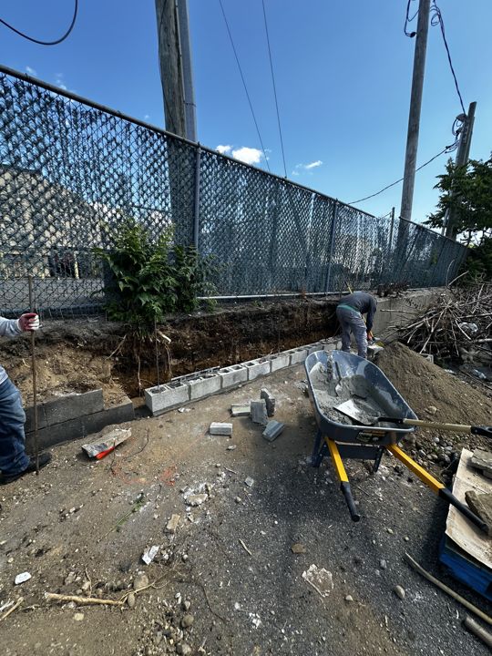 The old wall and debris before the work.