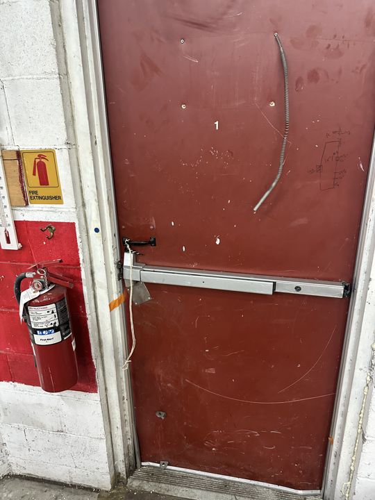 New steel exit door with panic hardware installed.