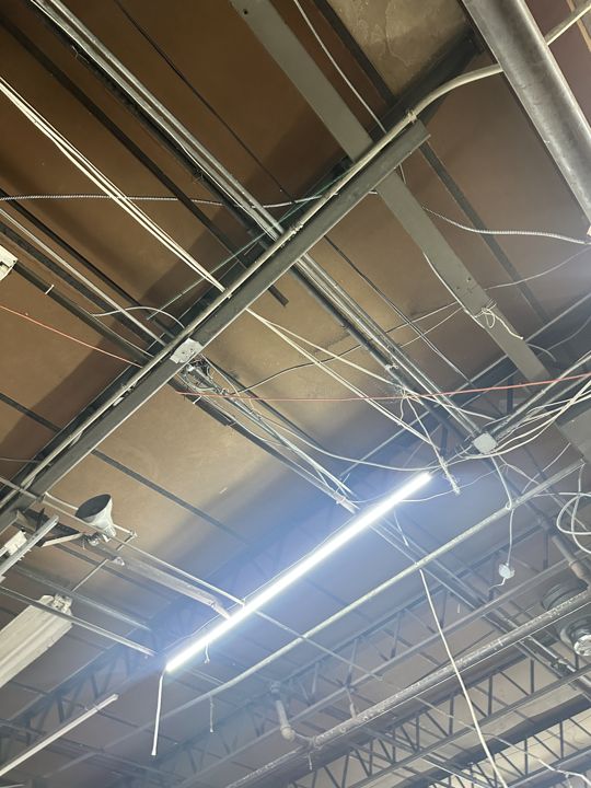 High-bay lighting repaired over the racking aisles.