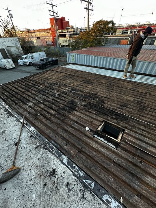 Rotted wood decking exposed during the roof-section replacement.
